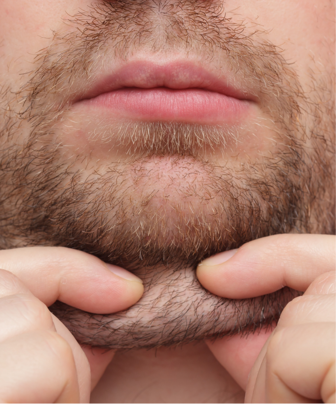 Man pulling on his chin fat