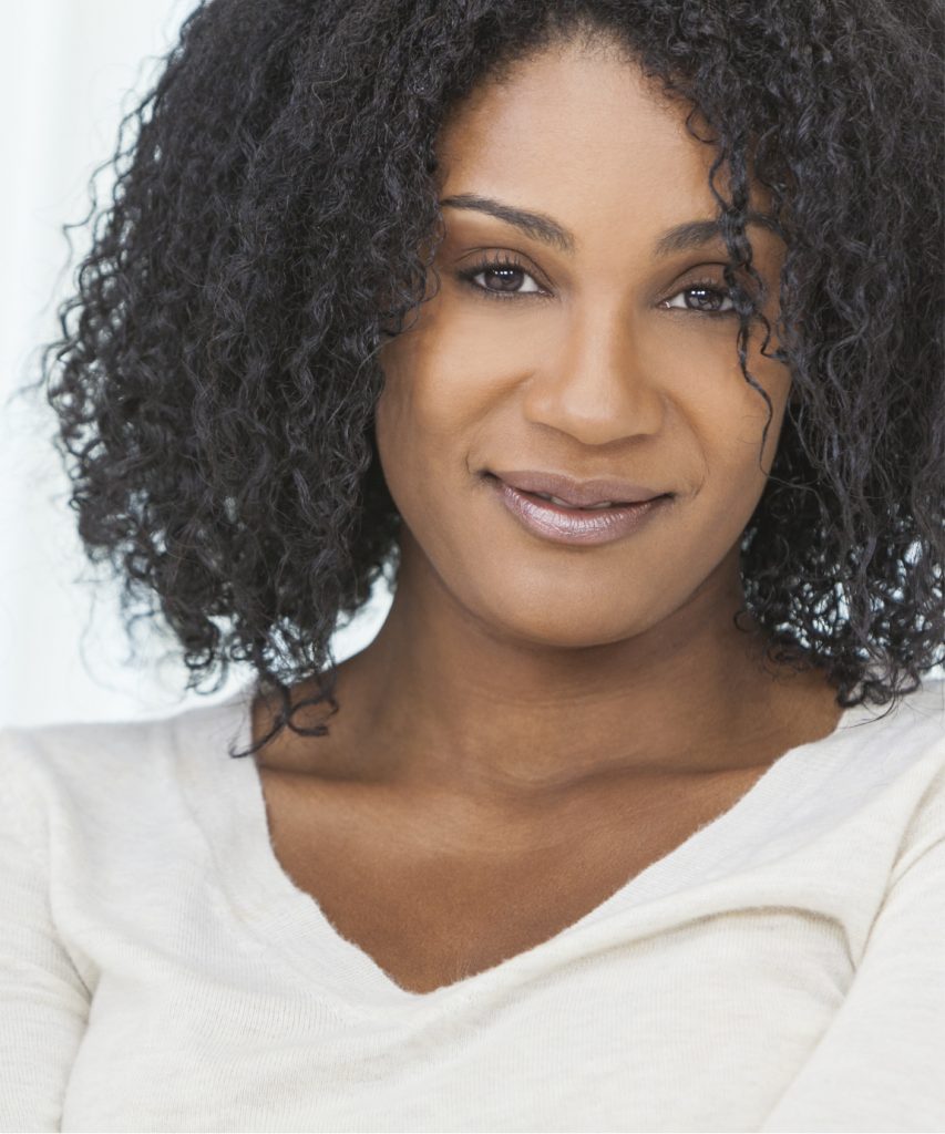 Smiling woman with dark curly hair