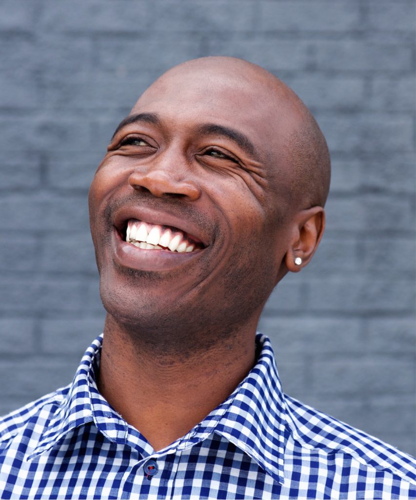 Smiling man in a blue and white checkered shirt
