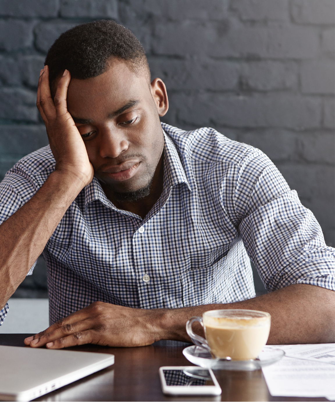 Man dealing with stress at a coffee shop