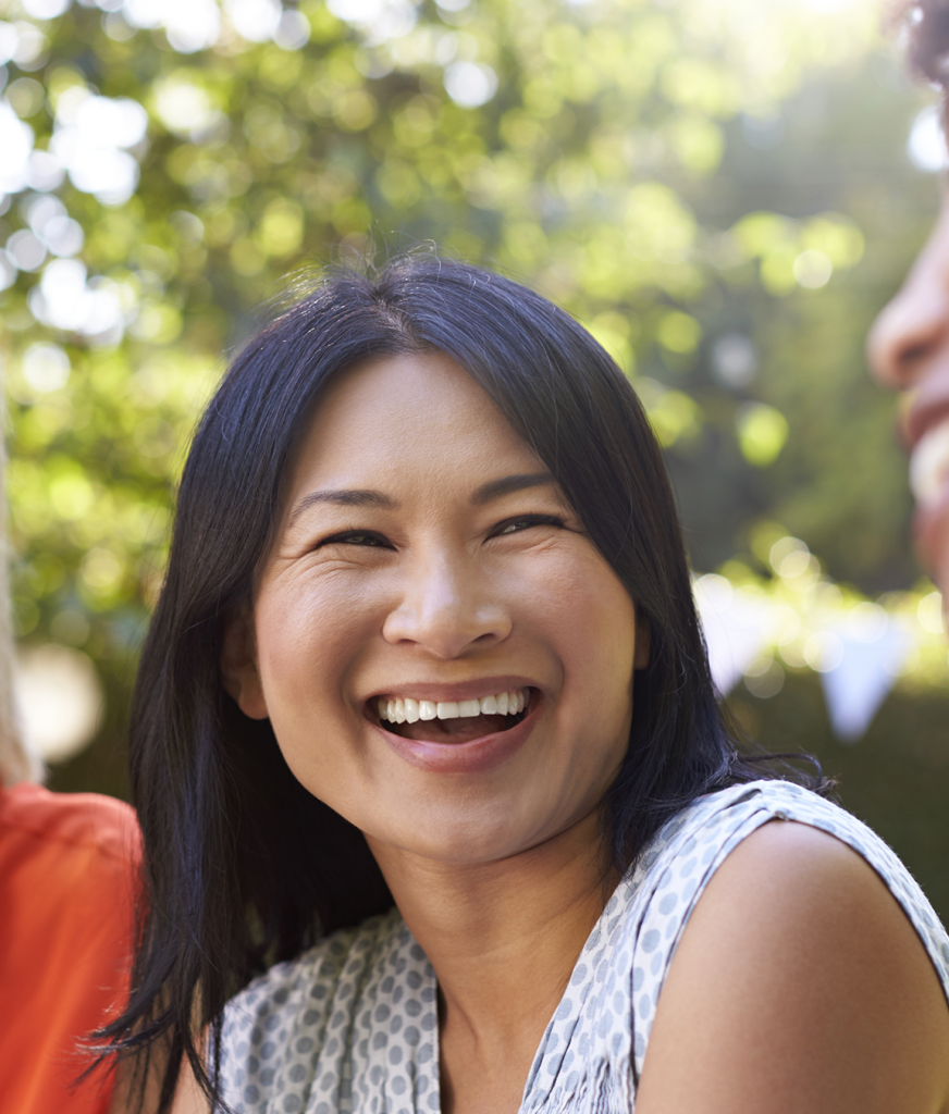 Smiling woman laughing with friends